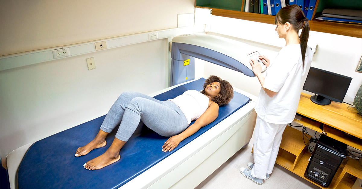 A woman receiving a DEXA scan in a clinical setting to assess body composition during weight loss treatment.