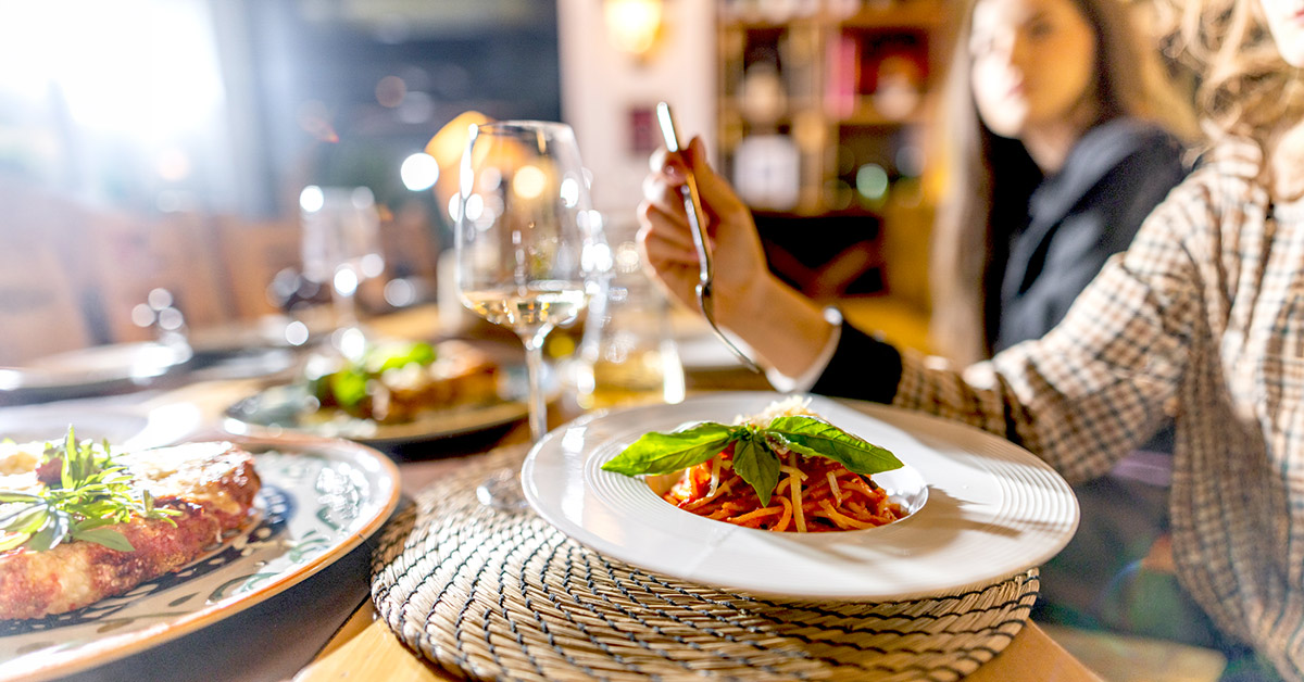 People at social gathering having dinner at restaurant.