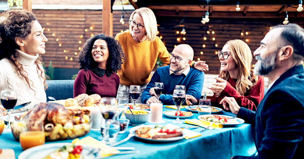 A group of happy friends celebrating around a feast table