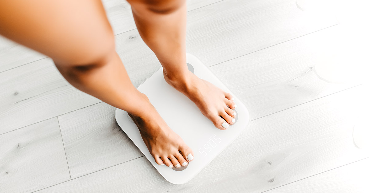Woman standing on weight scale