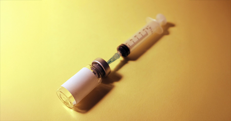Sample of a syringe connected to a white label bottle