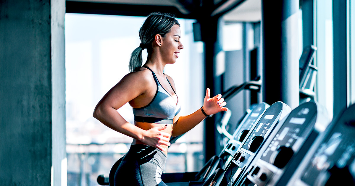 Athletic women running a treadmill at the gym