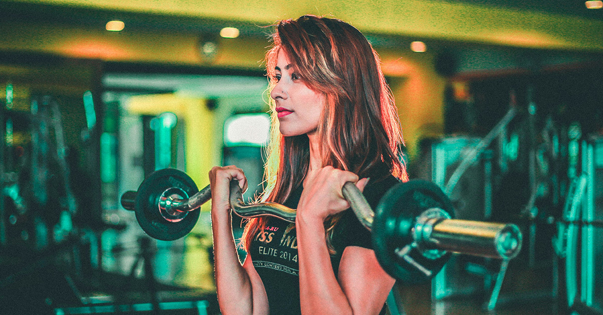 Women curling weights in the gym